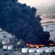 A plume of smoke rises from fire at the Intercontinental Terminals Company.